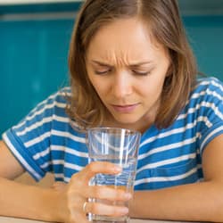 woman worried about what's in her glass